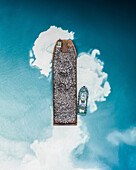 Aerial view of a construction ship carrying mountain rocks in island harbour near Kulhudhuhfushi, Haa Dhaal Atoll, Maldives.
