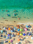 Aerial view of people on crowded beach enjoying summer, Lefkada, Greece.