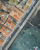 Aerial view of beautiful seafront with shops and promenade, Baiona, Spain.