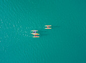Aerial view of group of people having fun while riding water bikes at lake Plastira in Greece