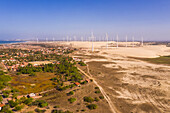 Aerial view of the beach shore with windmills in the background, Taiba, São Gonçalo do Amarante, Ceará, Brazil