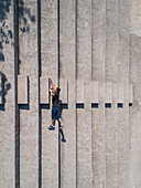 Optical illusion of a man falling created with a drone view.