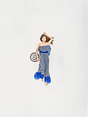 Aerial view woman lying on the roof on Santorini, Greece.