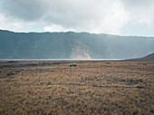 Aerial view of an all-terrain car under Mount Bromo, East Java, Indonesia