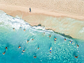 NIKITAS, GREECE - 13 JULY 2018: Aerial view of people enjoying the swimming in the sea on sandy beach.