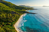 Aerial view of a paradise beach with granite formation along the shore near Grand Anse Bay, La Digue and Inner Islands, Seychelles.