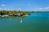 Aerial view of a ams all catamaran sailing along the coast at Pointe de Flacq, Mauritius.