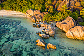Aerial view of people relaxing on the beach with granite formation at Anse Source d'Argent beach, La Digue and Inner Islands, Seychelles.
