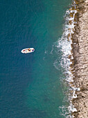 Aerial view of single speed boat floating over transparent water, Croatia.