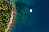 Aerial view of single speed boat floating over transparent water, Croatia.