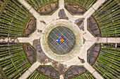 Aerial view of a man laying down on the floor of an abandoned Power plant reactor funnel in Charleroi, Belgium.