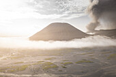 Aerial view of the majestic volcano with smoke and ash rising above the crater, Tosari, East Java, Indonesia.