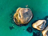 Aerial view of couple jumping off rock, Clifton, Cape Town, South Africa.