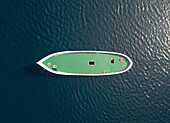 Aerial view above of unfinished boat anchored alone at Adriatic sea, Croatia.