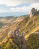Aerial view of a person on top of Le Chat y La Souris mountain or Mount Villars, in the Bambous Range near Grand Sable, Flacq, Mauritius.