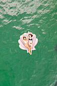 Aerial view of attractive girls with an inflatable at Gordons Bay, Sydney. Australia.