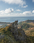 Aerial view of a person on top of Le Chat y La Souris mountain or Mount Villars, in the Bambous Range near Grand Sable, Flacq, Mauritius.
