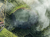 Aerial view of mystical Seven Lakes with lush vegetation and serene reflection, Capelas, Azores, Portugal.