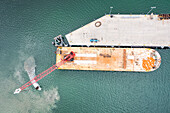 Aerial view of a cargo ship at the harbour on Unalaska island, Alaska, United States.