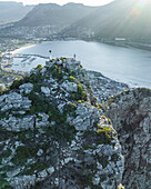 Aerial view of a person on Sentinel Peak along the Hout Bay, Cape Town, Western Cape, South Africa.