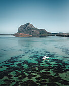 Aerial view of a water airplane landing in a lagoon with barrier reef with Le Morne Mountain in background, Le Morne Brabant, Riviere Noire, Mauritius.