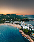 Aerial view of Shek O, a small settlement with beaches at sunset along the bay on Hong Kong island, China.