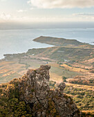 Aerial view of a person on top of Le Chat y La Souris mountain or Mount Villars, in the Bambous Range near Grand Sable, Flacq, Mauritius.