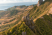 Aerial view of a person on top of Le Chat y La Souris mountain or Mount Villars, in the Bambous Range near Grand Sable, Flacq, Mauritius.