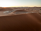 Aerial view of Sossusvlei and Deadvlei with sand dunes and persons, Hardap, Namibia.