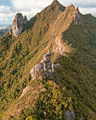 Aerial view of a person on top of Le Chat y La Souris mountain or Mount Villars, in the Bambous Range near Grand Sable, Flacq, Mauritius.