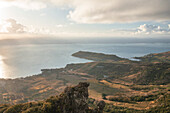 Aerial view of a person on top of Le Chat y La Souris mountain or Mount Villars, in the Bambous Range near Grand Sable, Flacq, Mauritius.