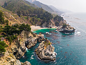 Aerial view of coastal rock formation with an dense pine tree forest, U.S.A.