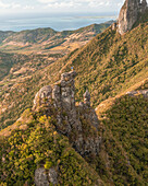 Aerial view of a person on top of Le Chat y La Souris mountain or Mount Villars, in the Bambous Range near Grand Sable, Flacq, Mauritius.