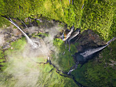 Aerial view above waterfall surrounding by jungle, Faroe Island.