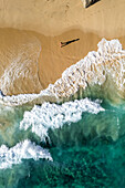 Aerial view of a person on the beach at Playa de los Amantes, Cabo San Lucas, Baja California, Mexico.