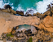 Aerial view of the Natural Bridge along the coastline with cliffs in Andicuri Bay, Paradera, Aruba.