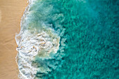 Aerial view of crispy waves along the shoreline at Playa de los Amantes, Cabo San Lucas, Baja California, Mexico.