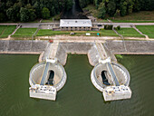 Aerial view of hydroelectric power plant and dam on Turawa Lake surrounded by forest, Turawa, Poland.