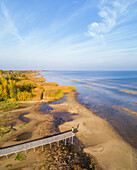 Aerial view of man standing on the edge of wood pier, Estonia.
