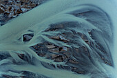 Aerial view of beautiful abstract blue patterns in the water of glacial river Héraosvotn in North Iceland.