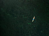 Aerial view of a boy swimming in the baltic sea in Estonia.