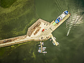 Aerial view of a jetski driving close to the harbour on Vormsi Island in Estonia