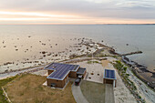 Aerial view of an isolated house with solar energy in the edge of a forest in Estonia.