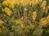Aerial view of a rusty tower in the middle of the forest in Estonia.