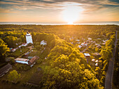 Aerial view of Suurupi lighthouse and campus at sunset in Estonia.