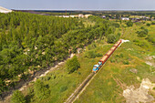 Aerial view of train carrying sand out of factory in Kiviõli, Estonia.