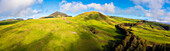 Panoramic aerial view of a cattle pasture, snow capped Mauna Kea in the distance, Waimea, Hawaii Island, Hawaii, United States.
