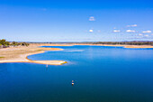 Aerial view of a woman Stand Up Paddle Boarding, Lake Wivenhoe, Queensland, Australia