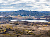 Aerial view of Kambavatn lake with mountain crests in background, Kirkjubaejarklaustur, Southern Region, Iceland.
