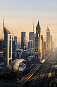 Dubai, United Arab Emirates - 17 February 2022: Aerial view of futuristic museum of the future and luxury skyscrapers with busy highway, Dubai, United Arab Emirates.